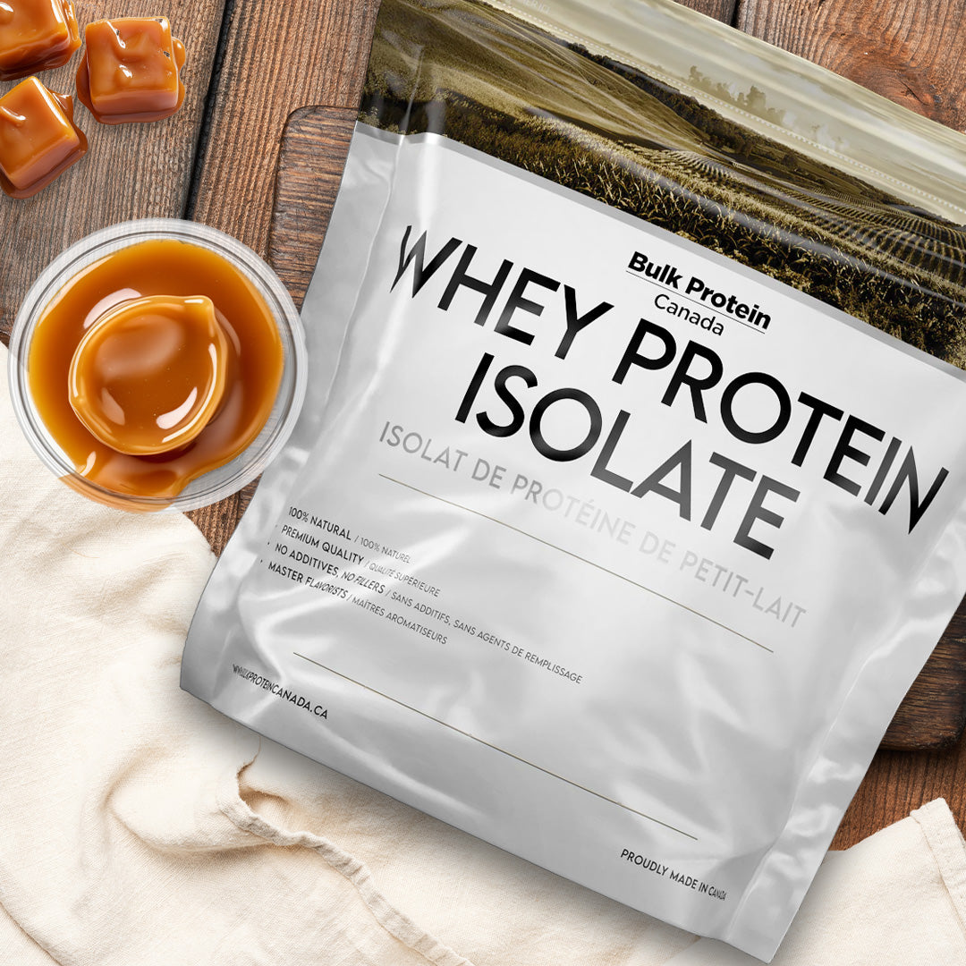 Bulk Protein Canada Butterscotch whey protein isolate on a table with butterscotch pieces