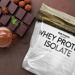 Bulk Protein Canada Chocolate whey protein isolate on a table with chocolate piece