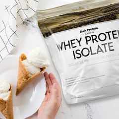 Bulk Protein Canada Vanilla whey protein isolate on a table with ice cream